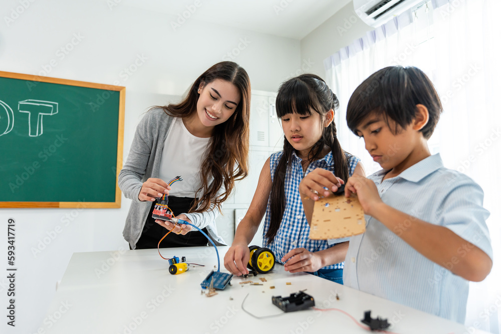 Group of student learn with teacher in classroom at elementary school.