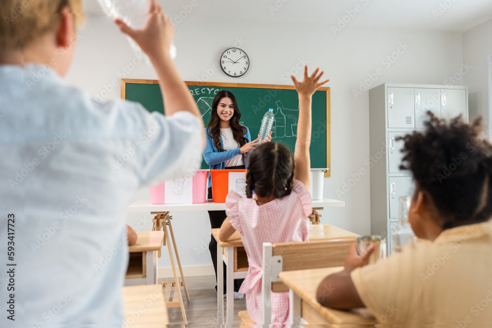 Group of student learn with teacher in classroom at elementary school. 