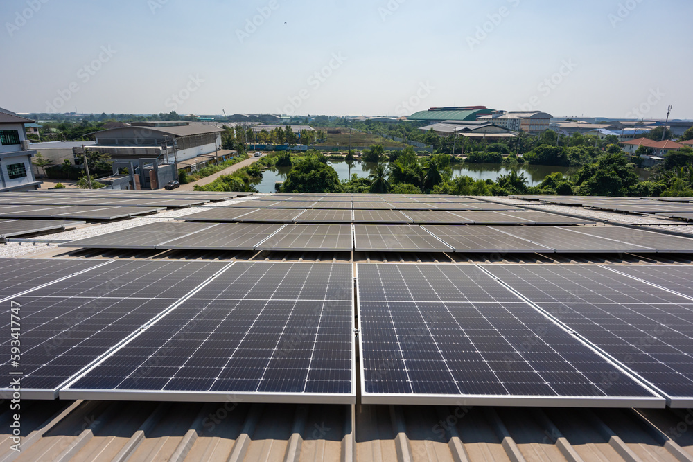 Aerial drone shot flying above ecology solar power station panels in field. 