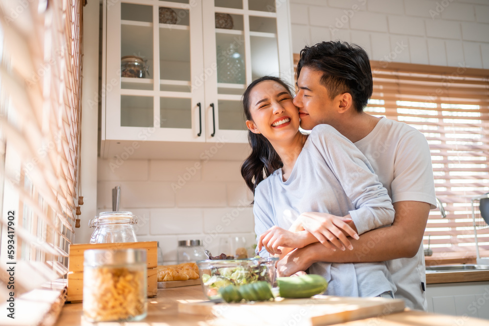 Asian young new marriage couple spend time together in kitchen at home. 