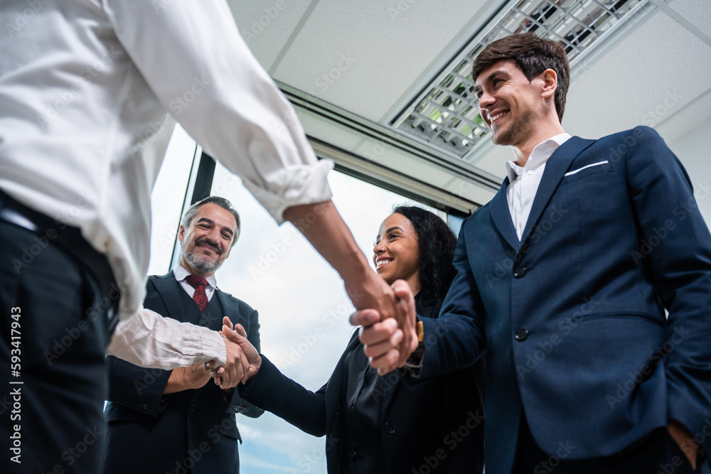 Caucasian businessman making a handshake together while stand in office. 