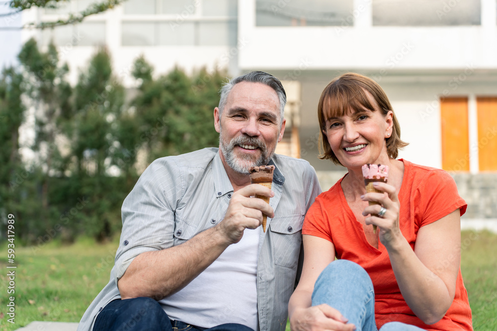 Portrait of Caucasian senior couple having a picnic outdoors in garden. 