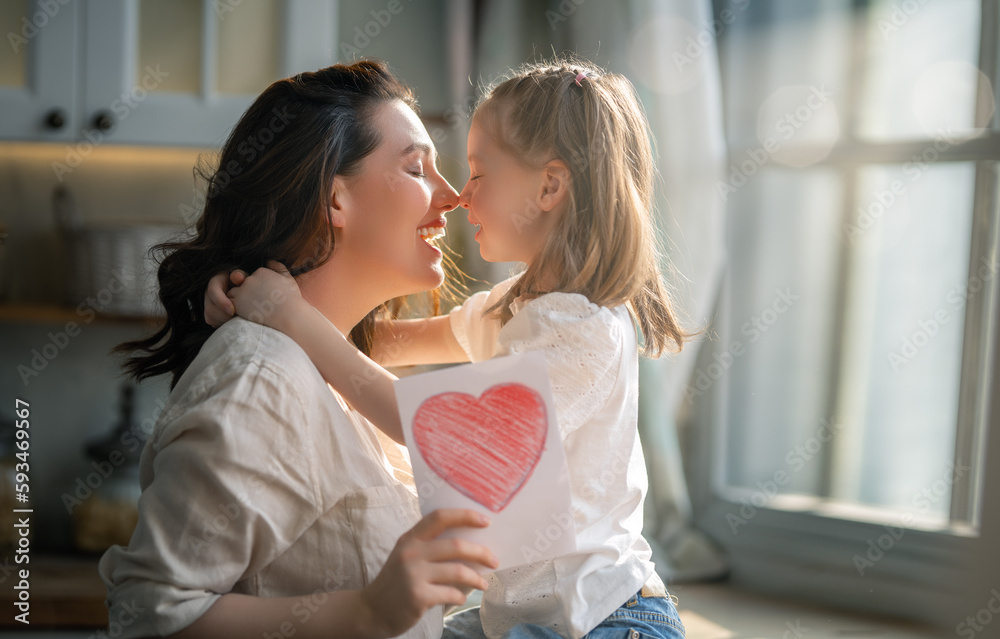 Daughter giving mother postcard.