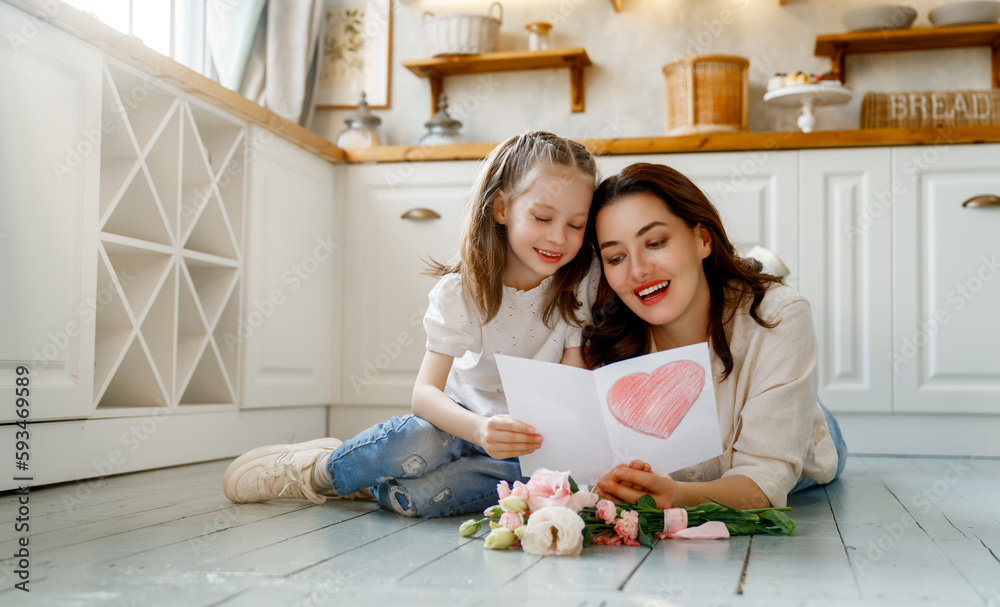 Daughter giving mother bouquet of flowers.