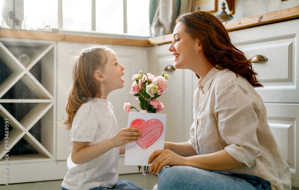 Daughter giving mother bouquet of flowers.