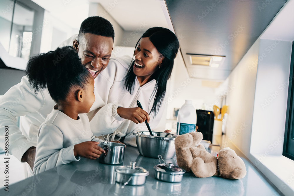 African family enjoying making breakfast together at home, couple cooking with their child