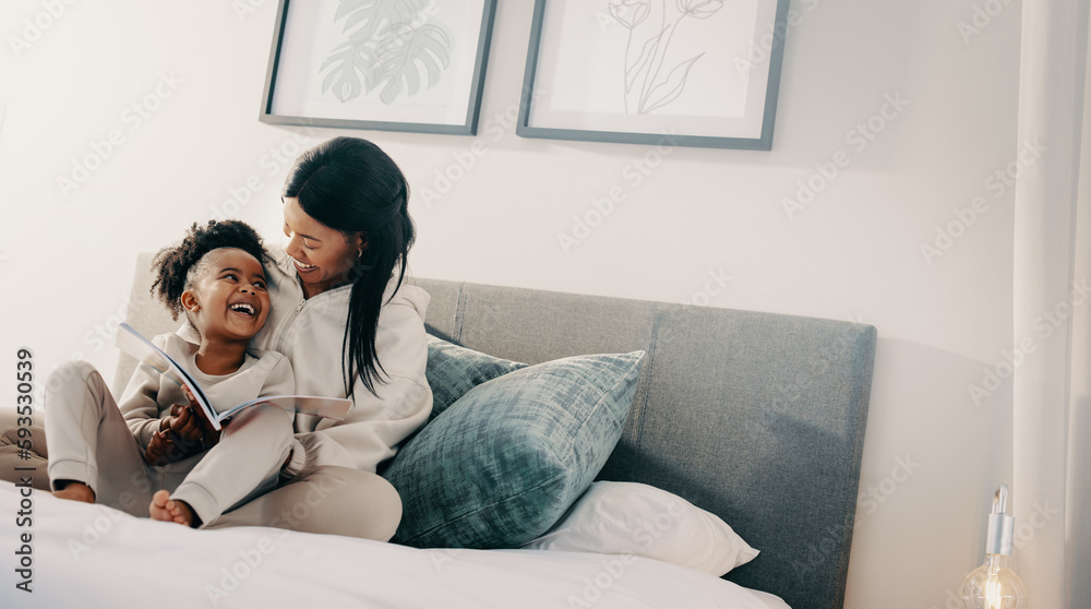 Woman smiles at her child while helping her read a book