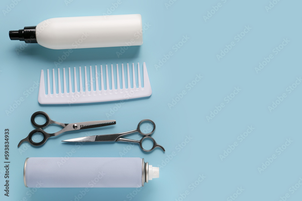 Composition with bottles of hair sprays, comb and scissors on color background