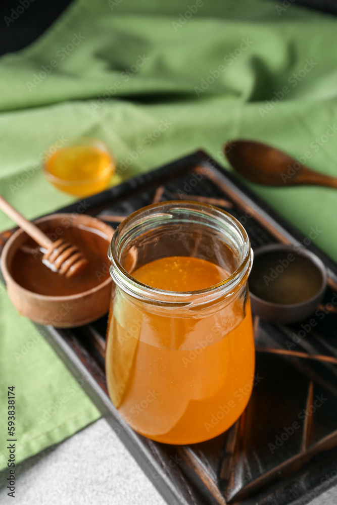 Jar of sweet honey on table