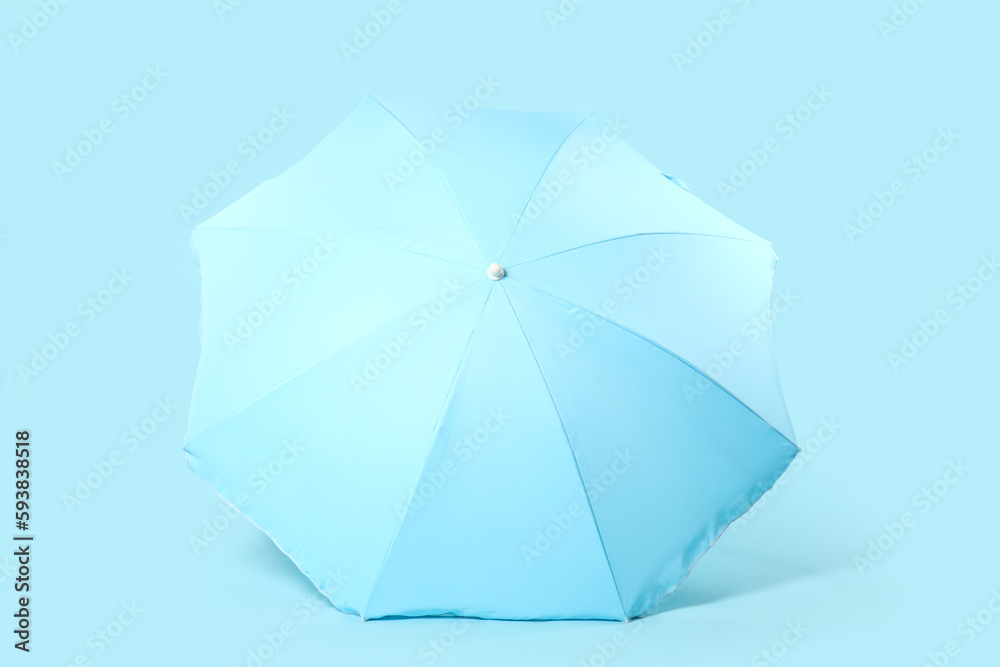 Beach umbrella on blue background