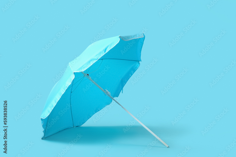 Beach umbrella on blue background