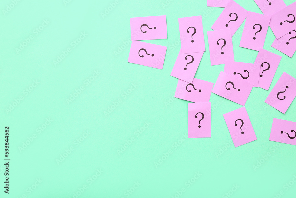 Papers with question marks on green background