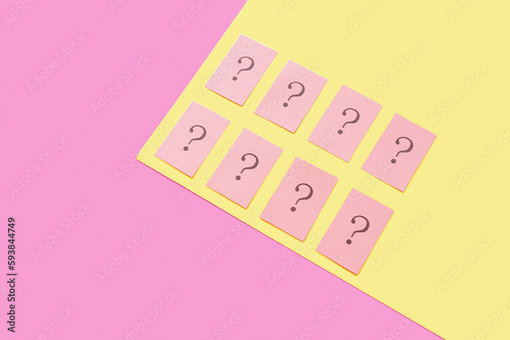 Papers with question marks on color background