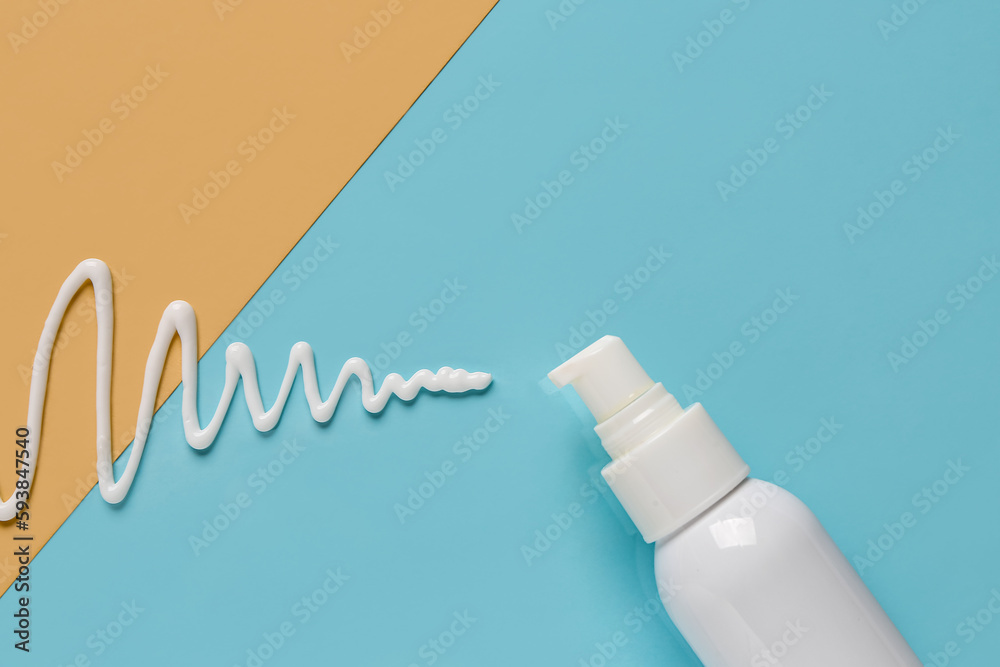 Bottle of sunscreen cream on color background, closeup