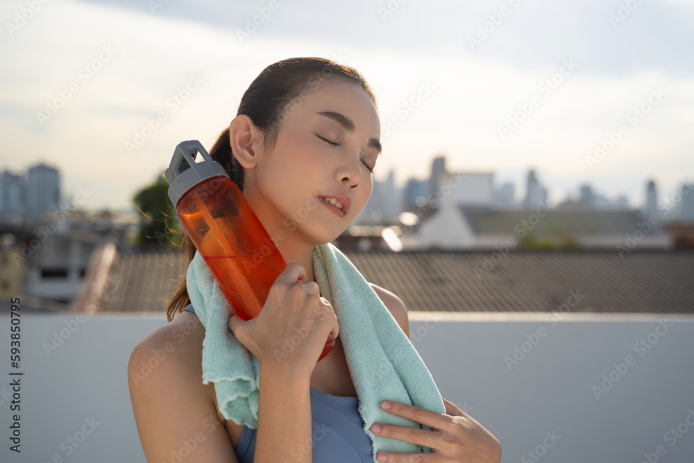 Young Asian woman resting after running exercise.outdoor exercise fitness concept