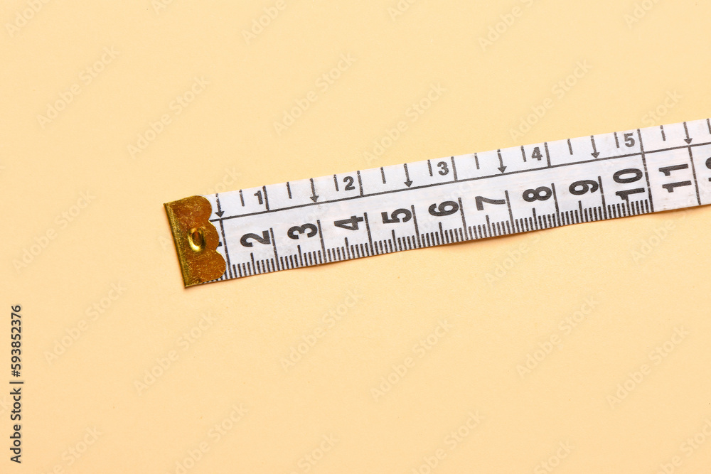 White measuring tape on beige background