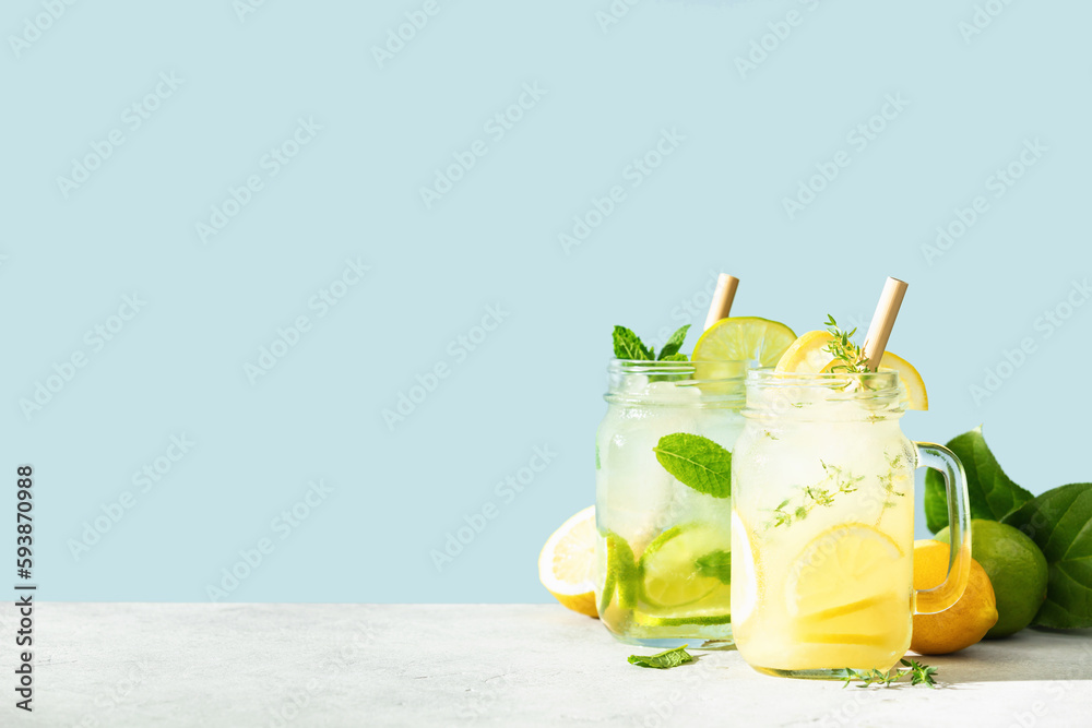 Lemonade and mojito on blue sky background close up