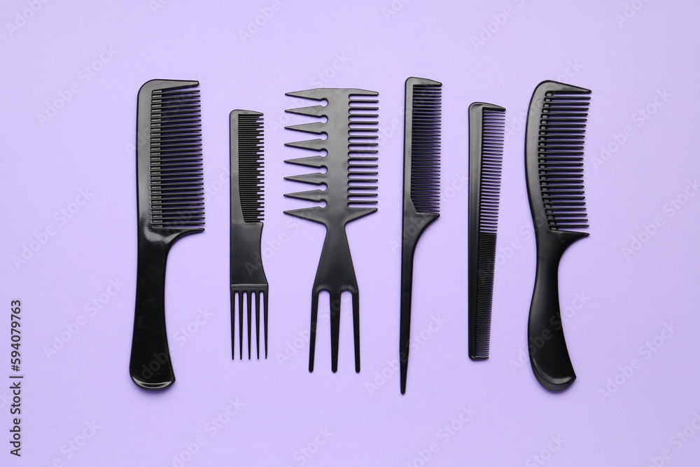 Hairdressers brushes on lilac background