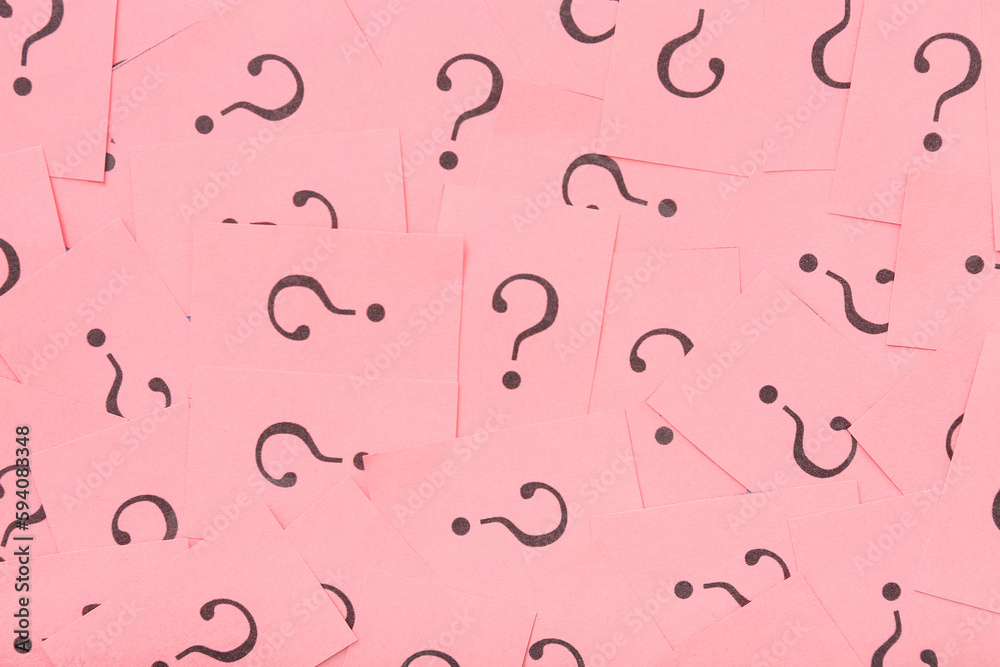 Pink papers with question marks as background