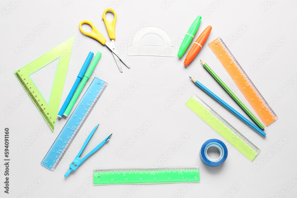 Frame made of stationery supplies on white background