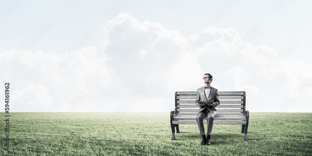 Young businessman or student studying the science in summer park