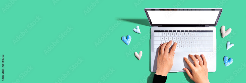 Laptop computer with heart cushions - flat lay