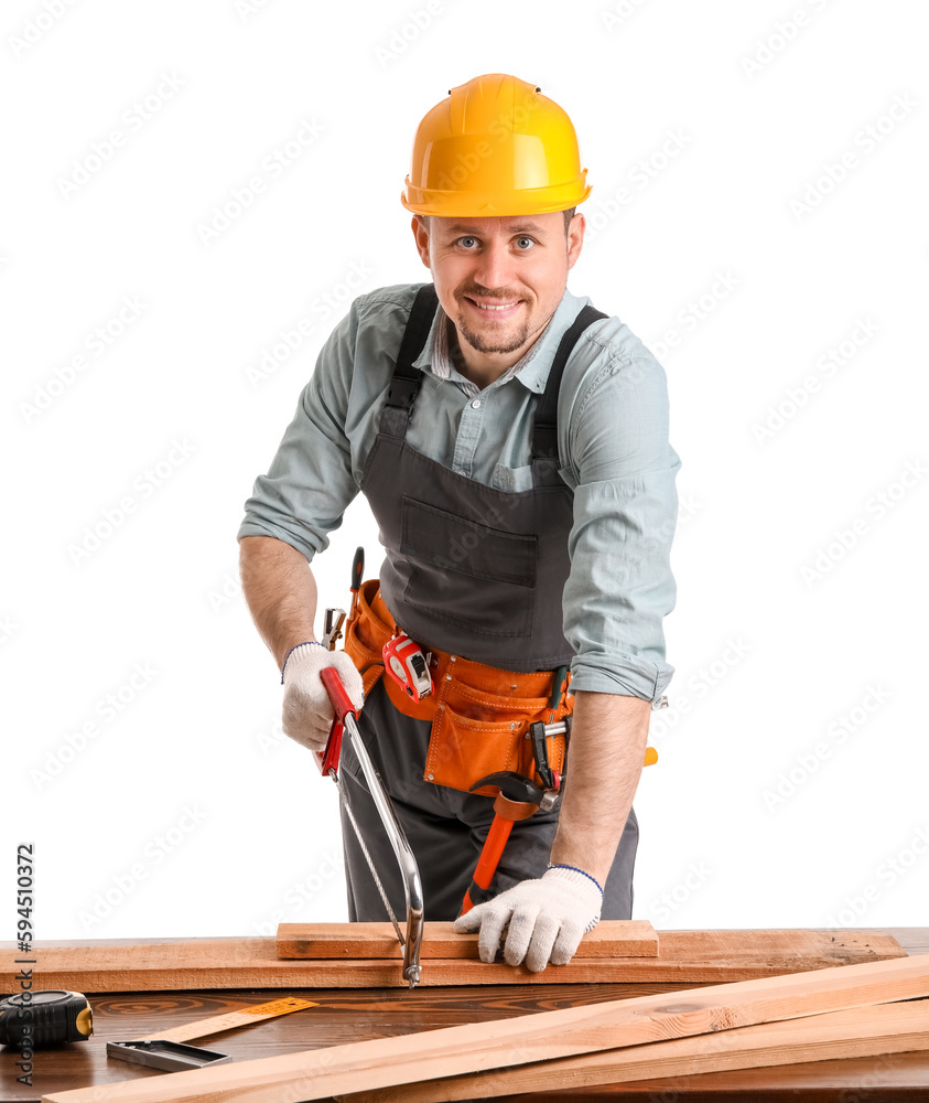 Male carpenter sawing wooden plank at table on white background