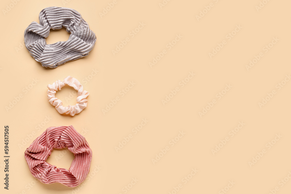 Set of different scrunchies on color background