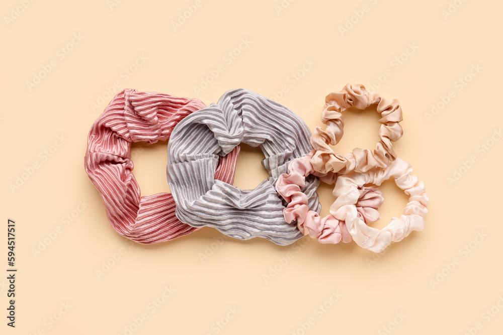 Set of different scrunchies on color background