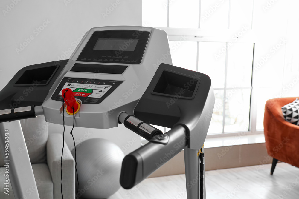 Modern treadmill in living room, closeup