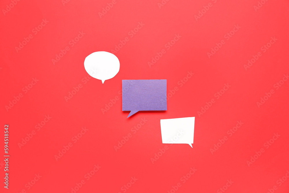 Blank paper speech bubbles on red background