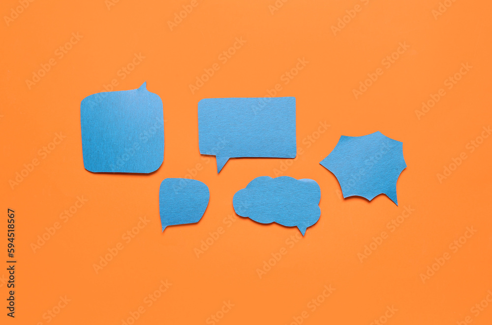 Blank paper speech bubbles on orange background