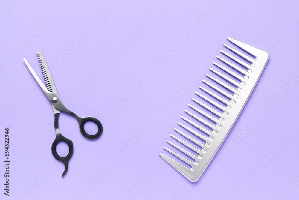 Hair comb with scissors on violet background