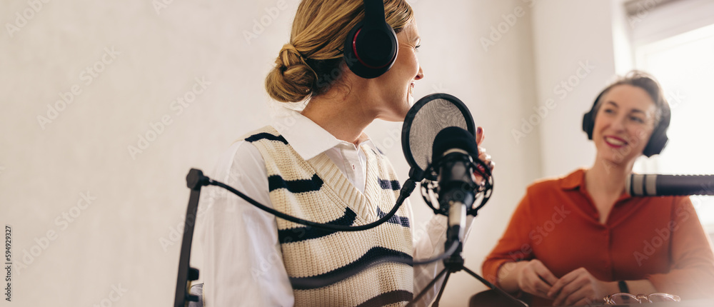 Happy radio host interviewing a guest on her show