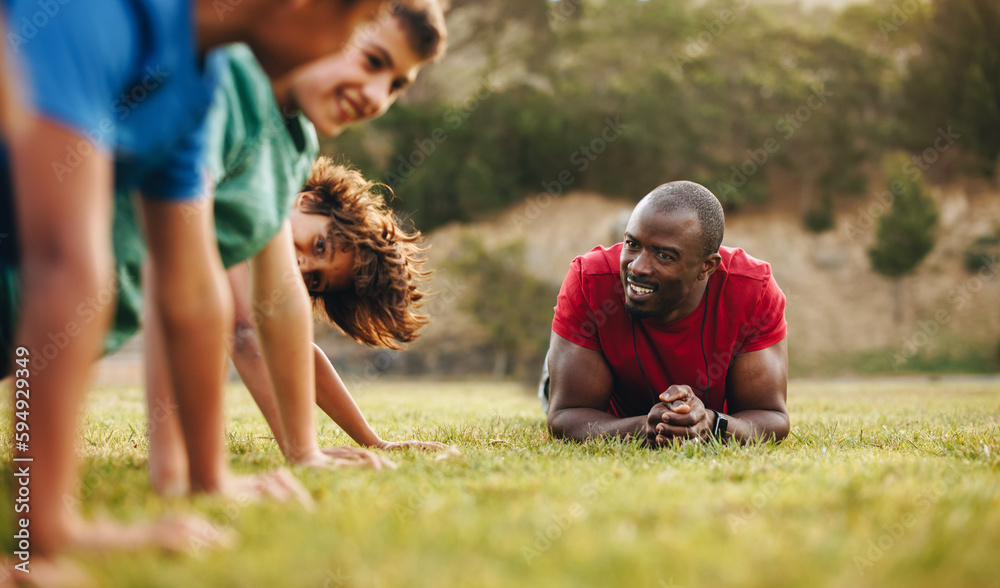 Rugby coach training a school team in a field