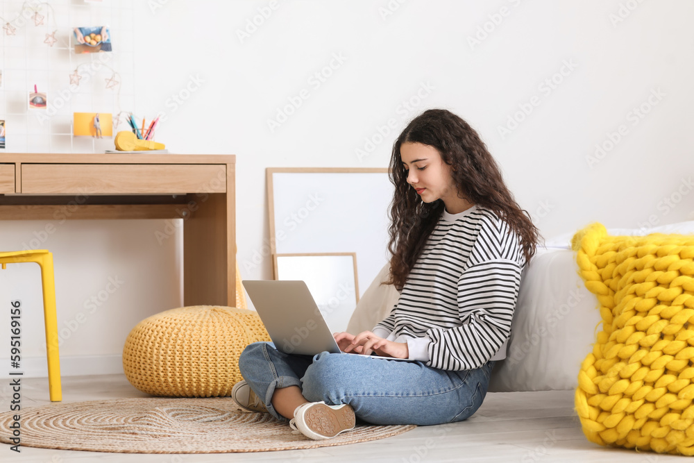 Female student using laptop at home