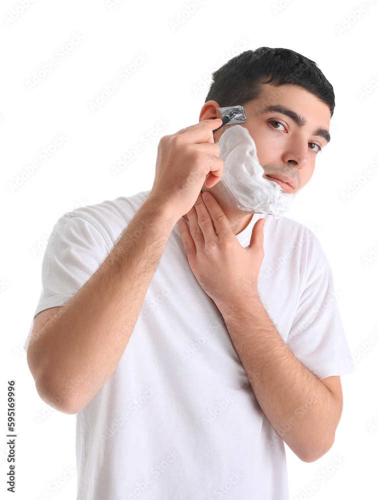 Young man shaving against white background