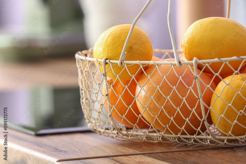 Basket with oranges on kitchen counter, closeup