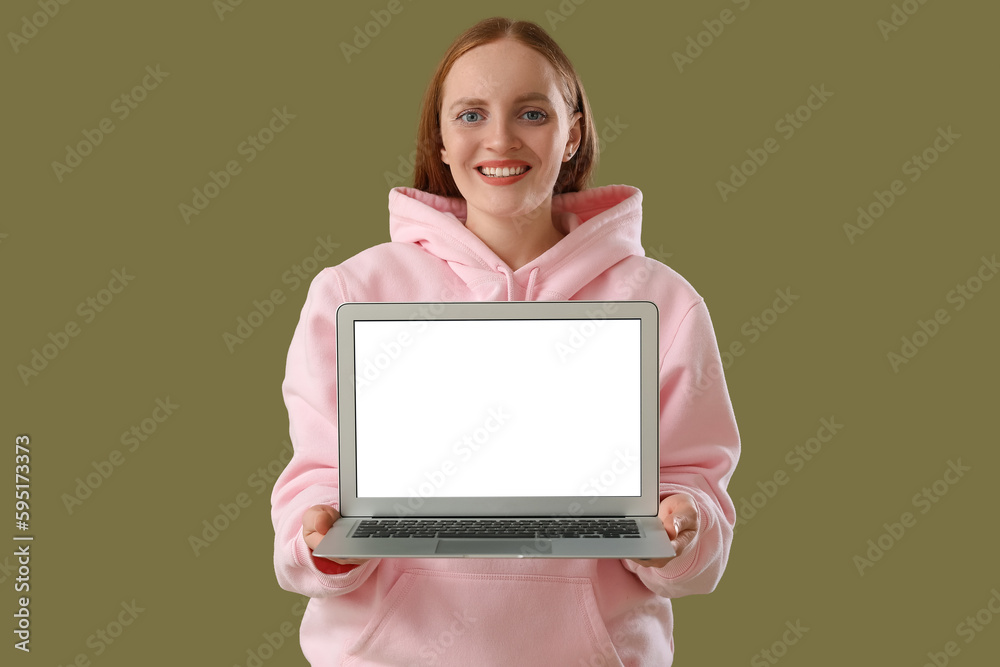 Female programmer with laptop on green background