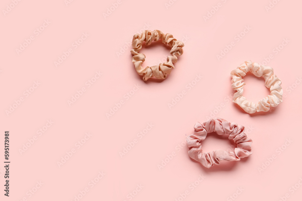 Set of silk scrunchies on pink background