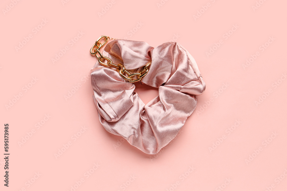 Silk scrunchy and bracelet on pink background