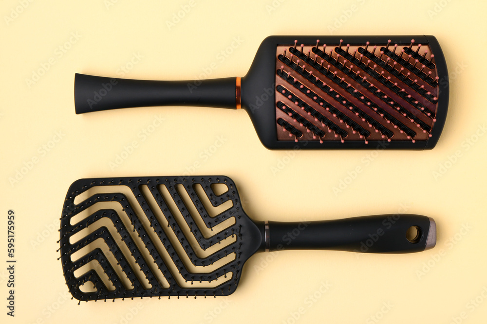 Hairdressers brushes on yellow background