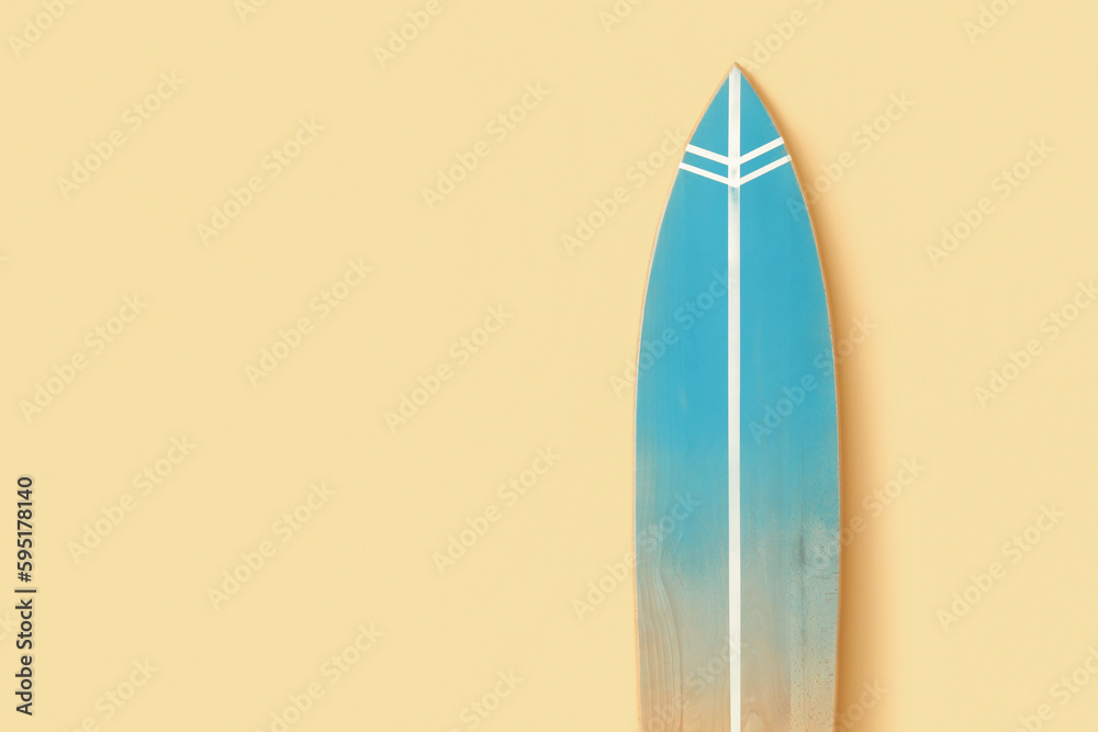 Wooden surfboard near beige wall, closeup