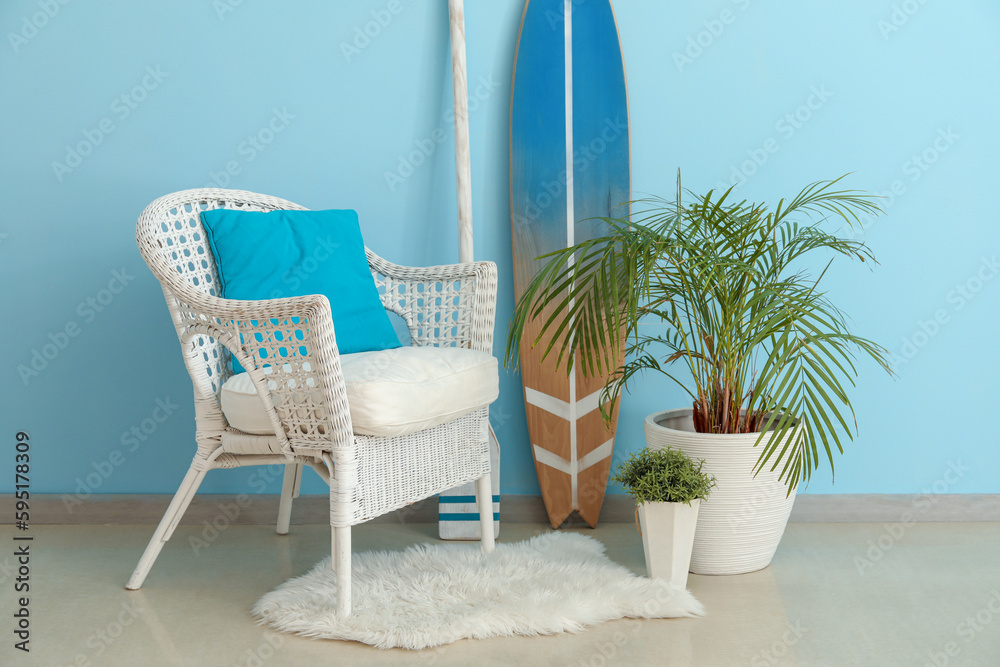 Interior of living room with surfboard, paddle and armchair