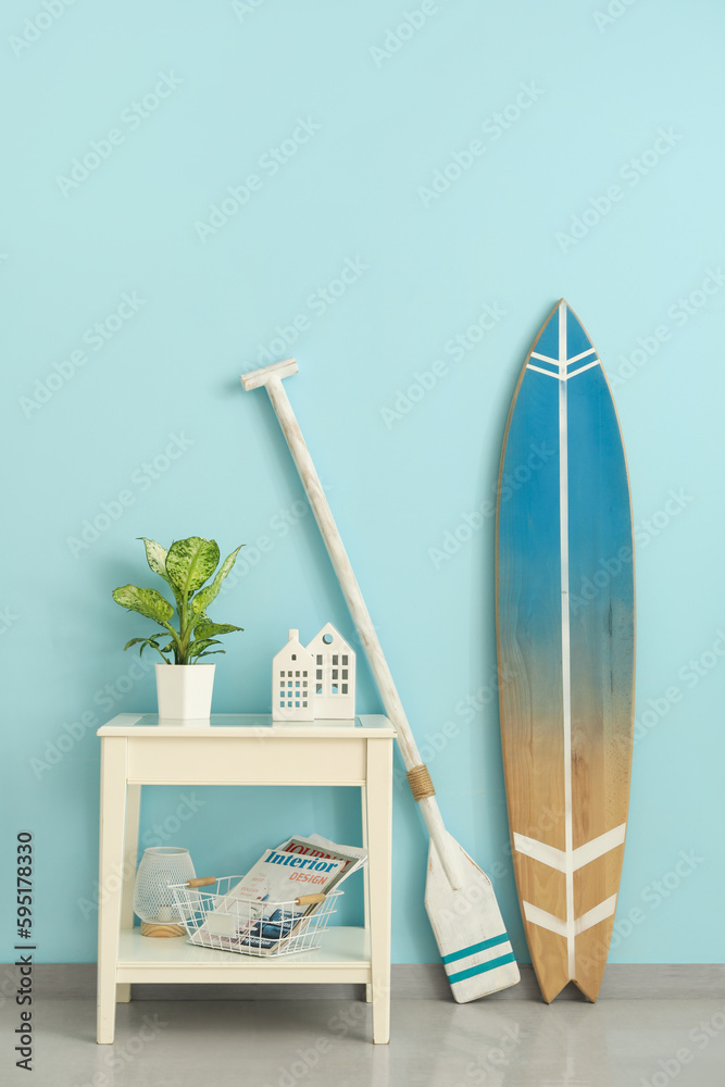 Interior of room with surfboard, paddle and table