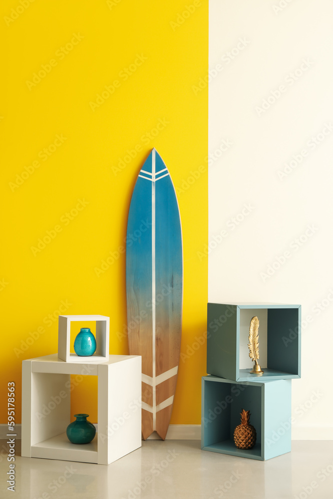 Surfboard with shelves near color wall in room