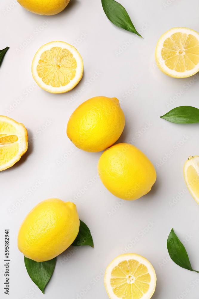 Composition with fresh lemons on grey background