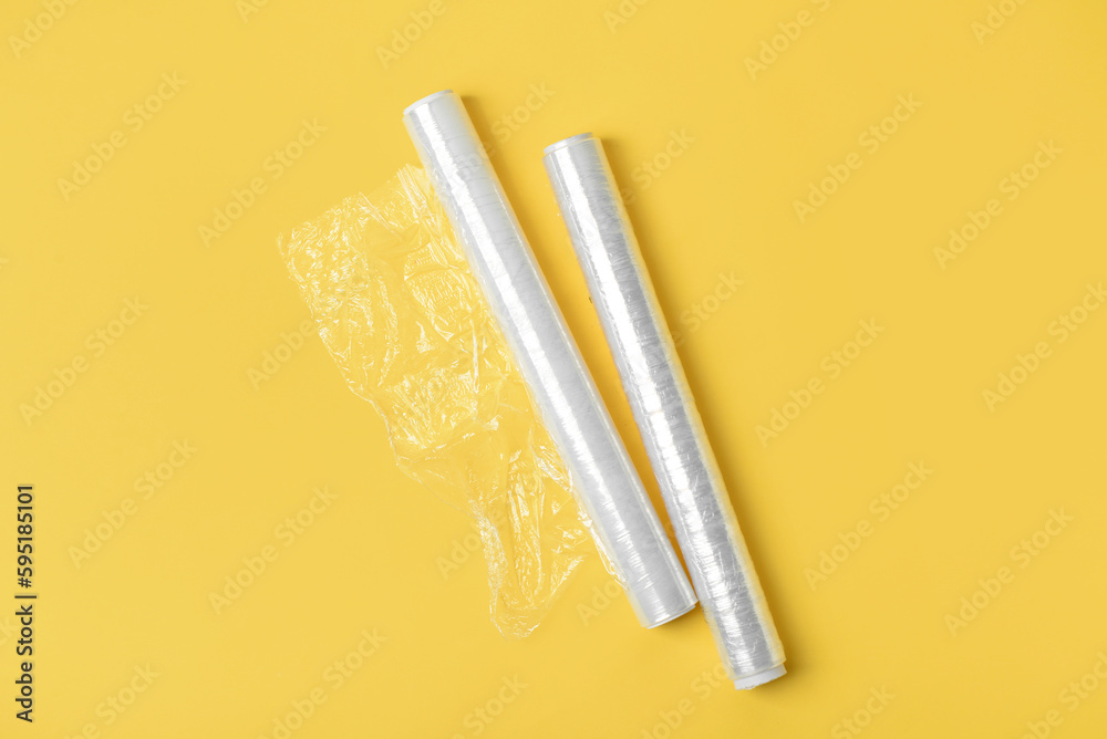 Rolls of stretch wrap on yellow background