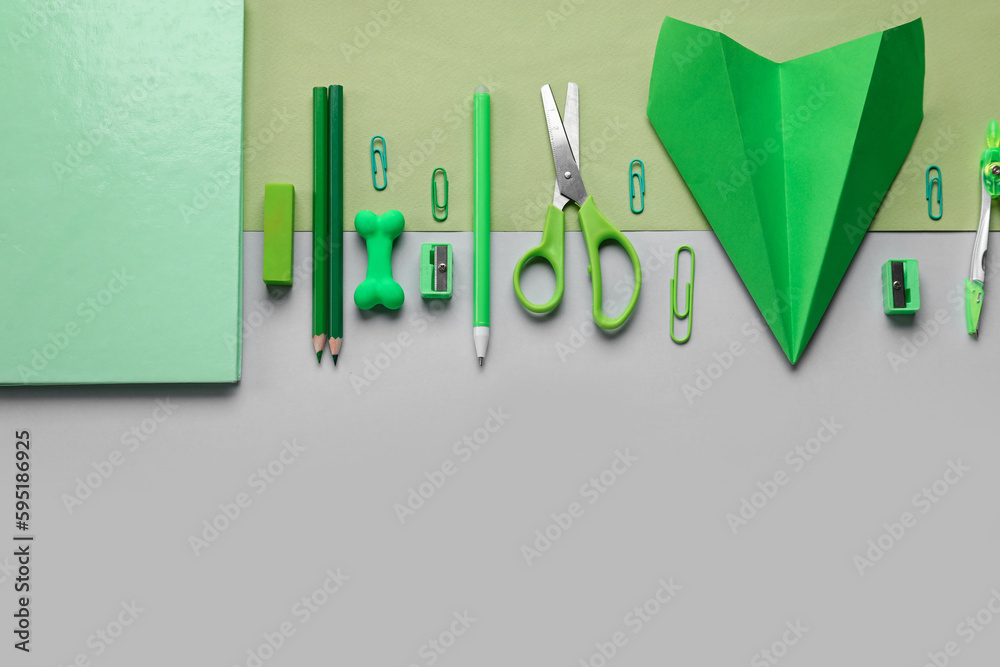 Composition with stationery supplies and paper plane on color background