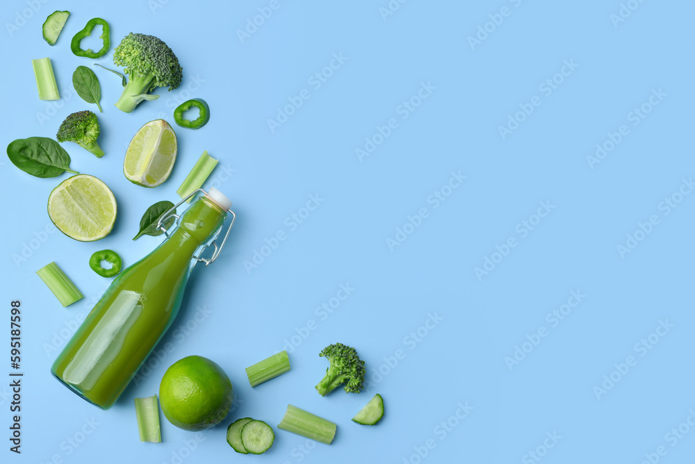 Glass bottle of tasty green juice and ingredients on blue background